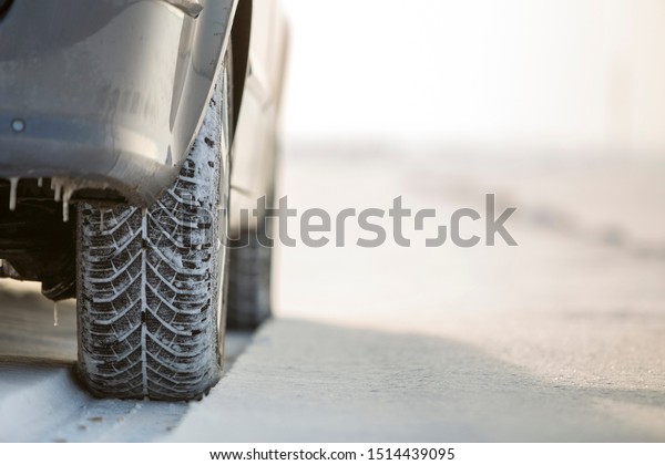 Close-up of car wheels rubber tire in deep snow.
Transportation and safety
concept.