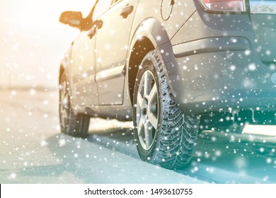 Close-up Of Car Wheels Rubber Tires In Deep Winter Snow. Transportation And Safety Concept.