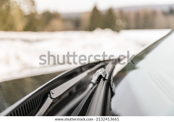 A closeup of car\
wiper blades in winter