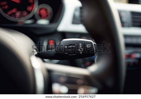 Close-up of car wipers control - modern car\
interior details, cockpit\
background