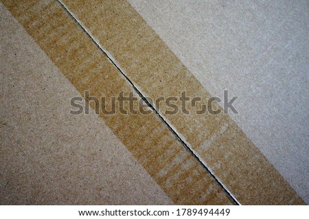Closeup of carboard box with adhesive tape cut open