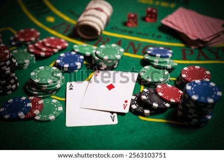 A closeup cards and different chips spread on a poker table