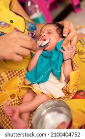 Close-up Of Caring Indian Mother Feeding Milk To Her A Newborn Baby With A Spoon. 