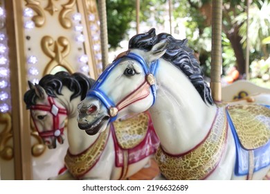 A close-up of the carousel with horses. 