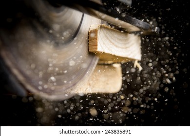Close-up of carpenter cutting a wooden plank 