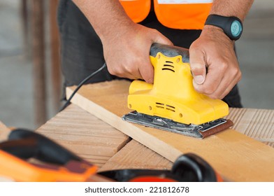 Closeup Of Carpenter Hand Sanding Plank With Electrical Sanding Machine  - Powered by Shutterstock