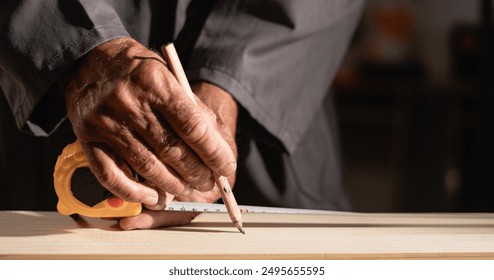 Close-up carpenter measure wood plank, craftsman making measurement on the wooden using ruler and pencil. Copy space. banner - Powered by Shutterstock