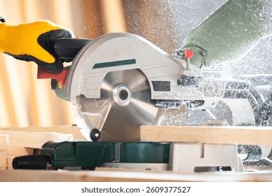 Close-up of a carpenter using a circular saw to cut a large board of wood 