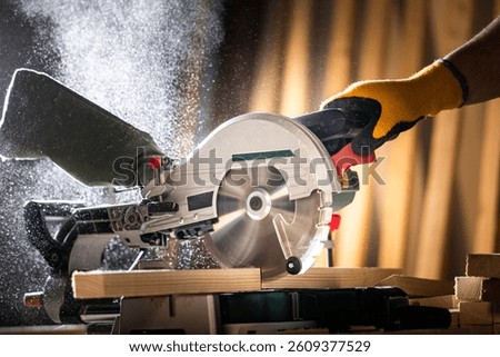Close-up of a carpenter using a circular saw to cut a large board of wood 