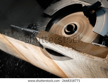 Close-up of a carpenter using a circular saw to cut a large board of wood 
