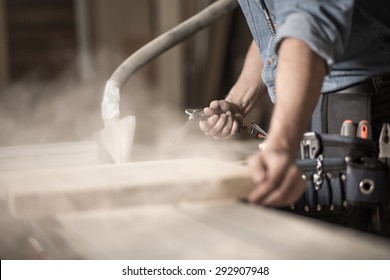 Close-up Of Carpenter's Hands Working With Wood