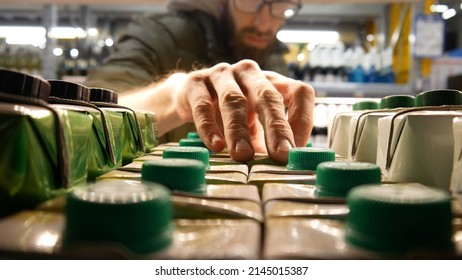 Close-up Of Carton Packaging Of Wine On A Store Shelf And A Man Takes One