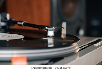 Close-up of a cartridge head on a vinyl record, analog retro music, vinyl disc collecting, vintage equipment - Powered by Shutterstock