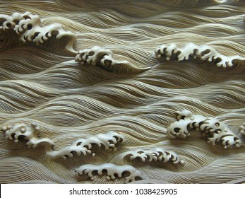 Closeup of carved ivory wave pattern.