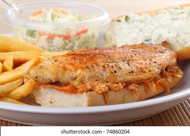 Closeup Of A Catfish Fillet Sandwich With French Fries And Coleslaw