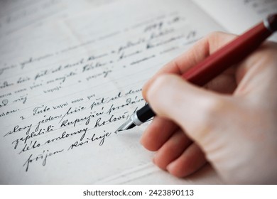 Close-up of a Caucasian female hand holding a fountain pen and writing a purchase contract in Czech language. Concept for old law, legal issues and old handwritten documents. - Powered by Shutterstock
