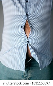 Closeup Of A Caucasian Man, With A Beer Belly Seen Through The Buttons Of His Shirt