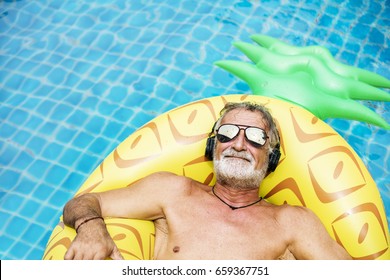 Closeup of caucasian senior man in the pool with headphones - Powered by Shutterstock