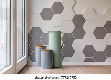 Close-up Of Ceramic Containers, Jug And Hexagon Tiles In Kitchen
