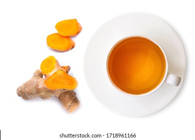 Closeup ceramic cup of hot Turmeric tea with tumeric root with slice  isolated on white background . Healthy drinks and health food boost immune system concept. Top view. Flat lay.