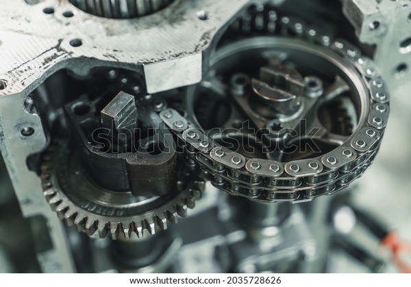 Close-up of the chain and gears of a car engine.\
Car engine repair