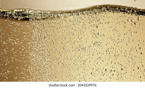 Close-up of champagne bubbles background with foam. Texture of beverages background. - Powered by Shutterstock