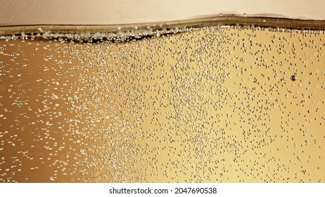 Close-up Of Champagne Bubbles Background With Foam. Texture Of Beverages Background.