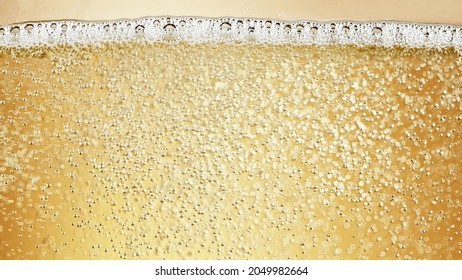 Close-up Of Champagne Bubbles Background With Foam. Texture Of Beverages Background.