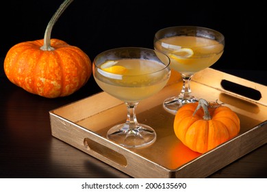 Closeup of Champagne Cocktail on a tray with mini pumpkins. Fall Drinks series.