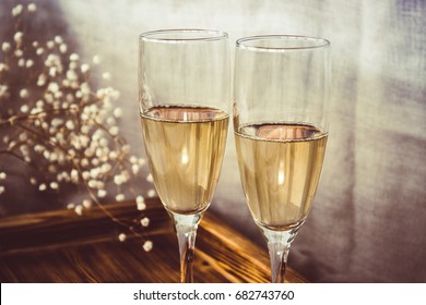 Close-up of champagne flutes, wine glasses and wooden tray,  on the wedding table, Mockup. Vintage rustic style. - Powered by Shutterstock