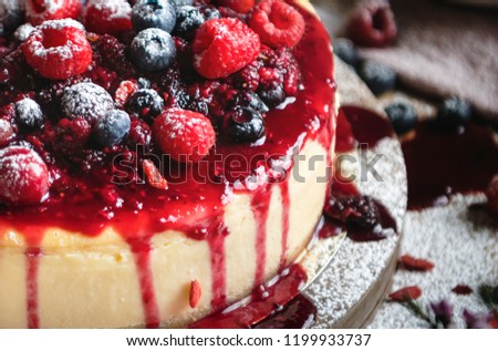 Closeup of a cheesecake covered with mixed berries