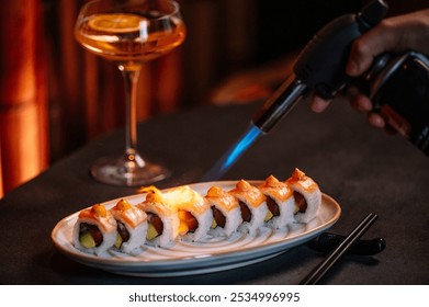 Close-up of a chef carefully searing a nigiri sushi with a culinary blowtorch. - Powered by Shutterstock