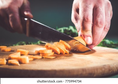 Close-up of chef carrot with kitchen knife on cutting board. - Powered by Shutterstock