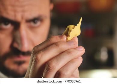 Close-up of a chef preparing ravioli, a typical Italian dish, homemade according to the ancient Italian tradition. Concept of: tradition, fresh pasta, italian food.