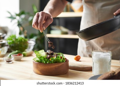 Close-up of chef putting fried meat on the plate with vegetables he cooking dish from chef - Powered by Shutterstock