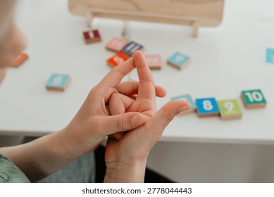 Close-up of a child counting numbers using fingers. Simple and intuitive learning method supporting early math development and number recognition.