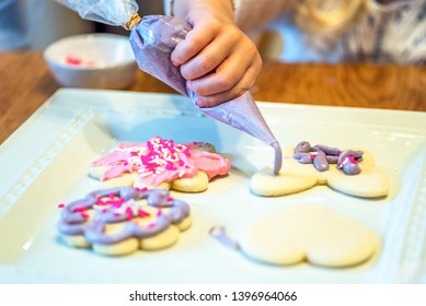 Closeup Of Child Decorating Sugar Cookies