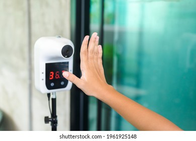 Closeup Child Hand At The  Temperature Meter Stand In Front Of The Restaurant, Check The Body Temperature During Covid-19 Pandemic