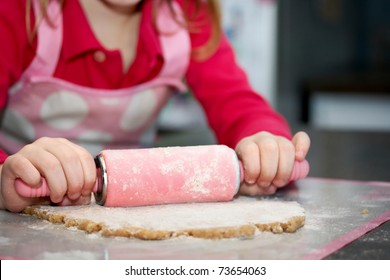 Close-up Of Child With A Rolling Pin Baking Cookies