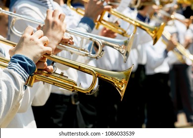 Closeup Of Children's Brass Band. Children Play On Golden Pipes. The Concept Of Lifestyle And Youth Culture.