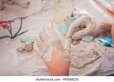 Closeup Of Children's Dirty Hands In Clay; Art Therapy