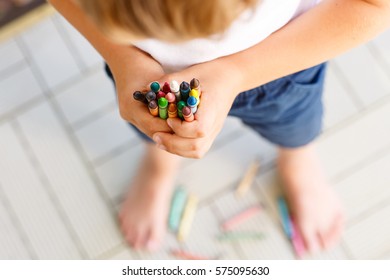 Closeup Of Child's Hands With Lots Of Colorful Wax Crayons Pencils. Kid Preparing Stationary And Student Stuff. Back To School Concept