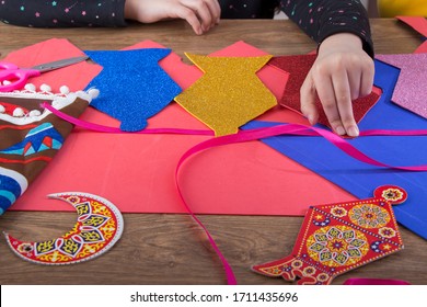 Closeup Of A Child's Hands Preparing Home Decoration Of Ramadan Using Colorful Paper - Diy Handmade Ramadan Zeena And Lantern