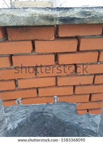closeup of chimney with missing mortar joints and old flashing