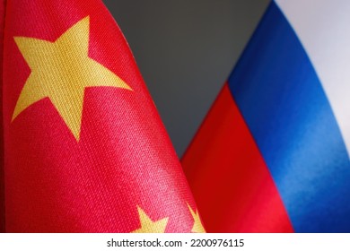 Close-up Of Chinese And Russian Flags As A Symbol Of Cooperation.