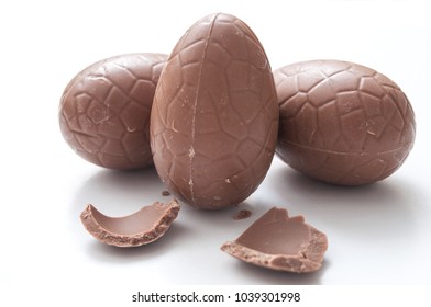 closeup of chocolate easter eggs broken on white background
