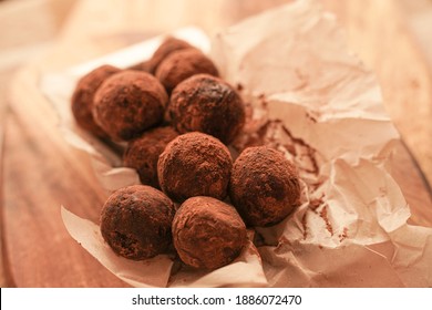 Close-up Of Chocolate Truffles On A Wooden Plank In Dark Aesthetic. Keto Dessert