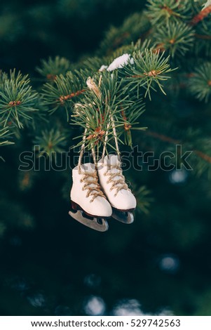 Closeup christmas tree decoration handmade miniature ice skates on the branch