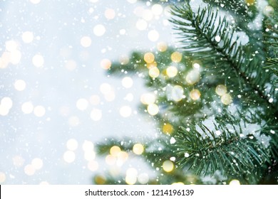 Closeup of Christmas tree with light, snow flake. Christmas and New Year holiday background. vintage color tone.