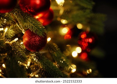 Close-up of Christmas tree with red balls and bokeh in the background. Background with copy space for holiday design. - Powered by Shutterstock